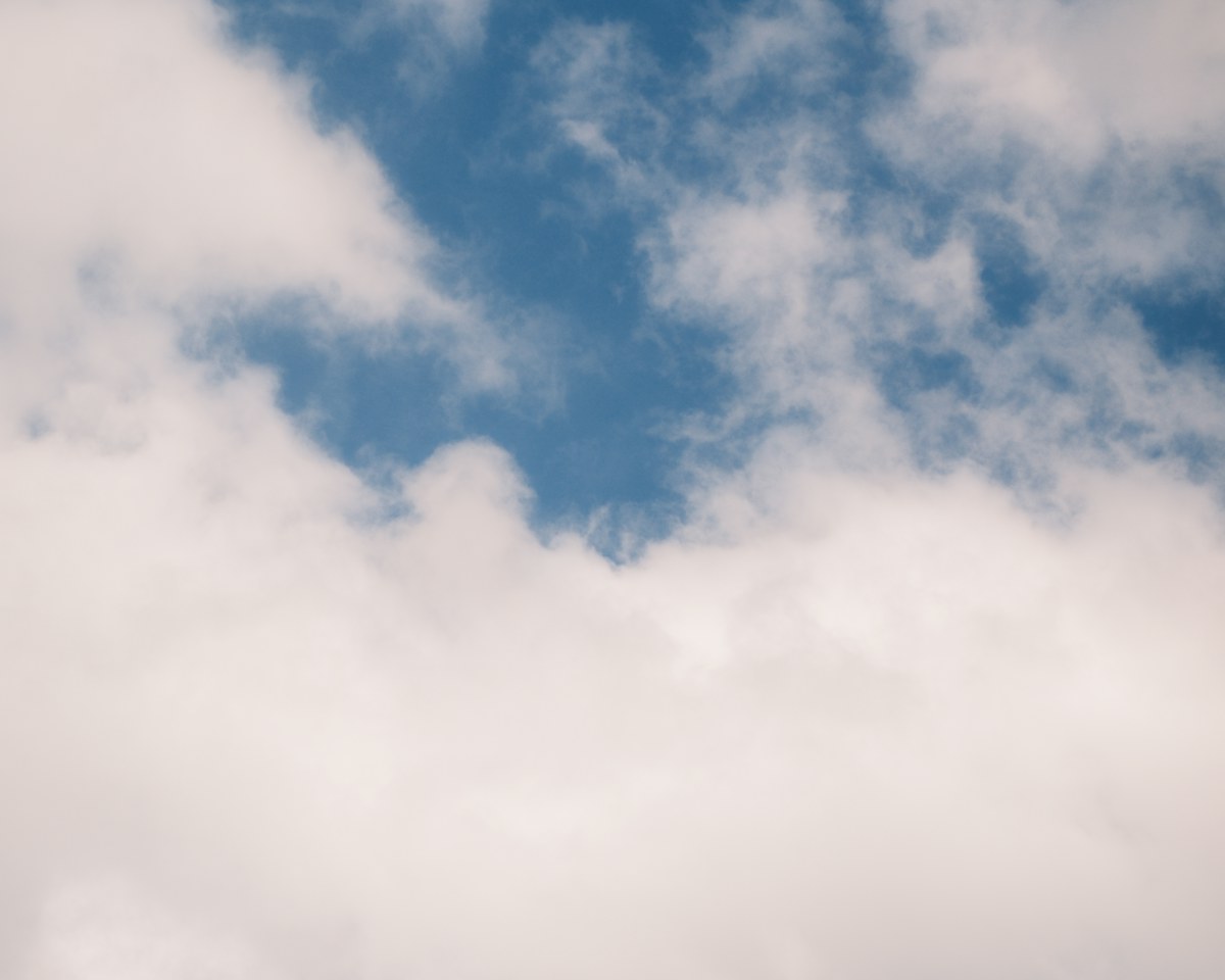 White clouds surround an opening of blue sky. Illustrative photo for this preview activity.