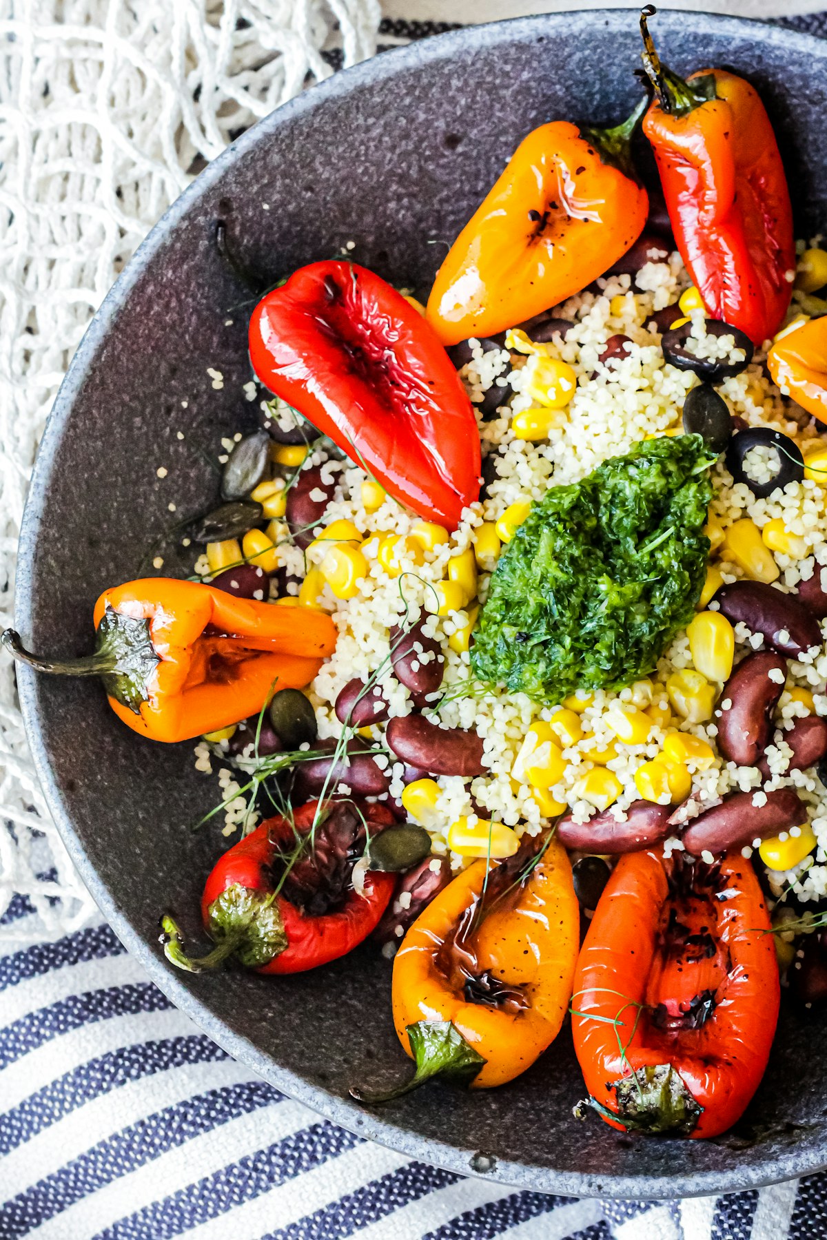 Couscous and vegetables in a blue bowl. Illustrative food photograph; the finished recipe may look different.