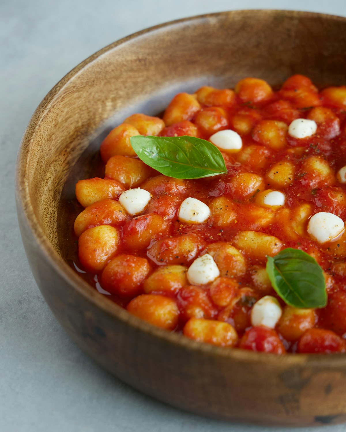 Gnocchi with tomato sauce, mozzarella, and basil. Illustrative food photograph; the finished recipe may look different.