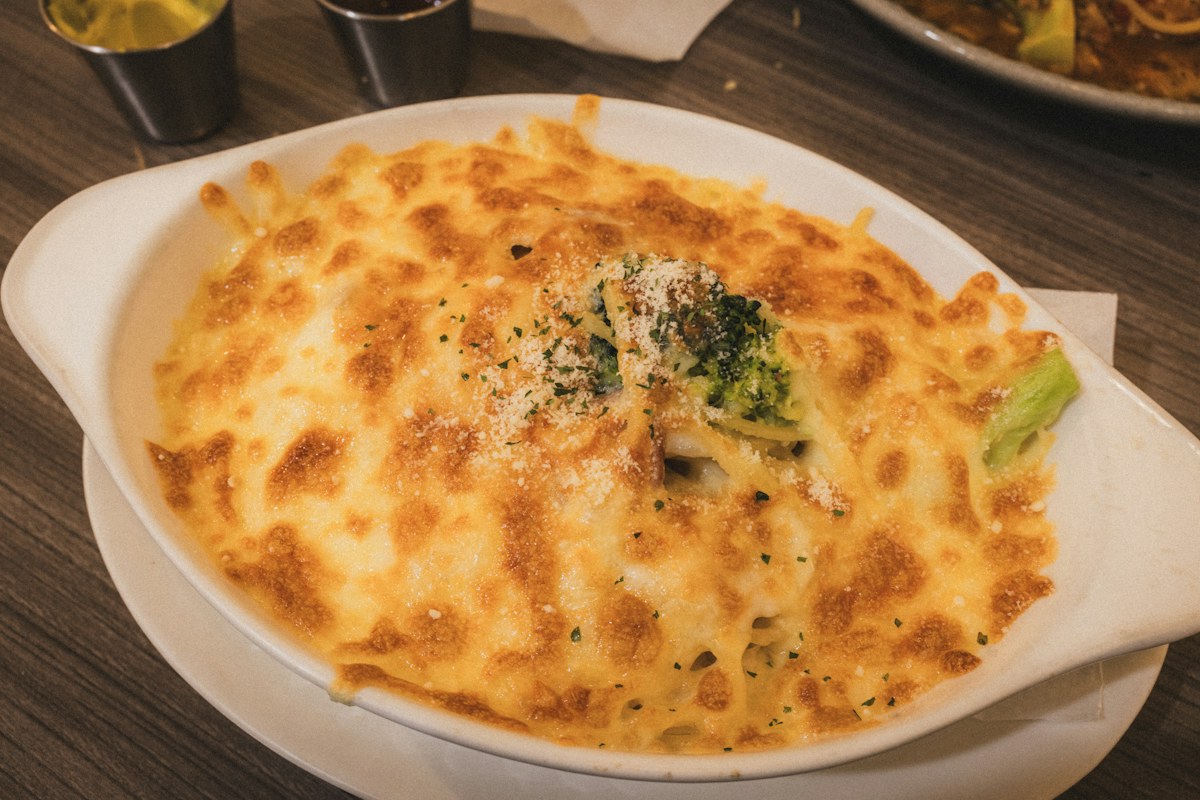 Broccoli and cheese gratin in a white baking dish. Illustrative food photograph; the finished recipe may look different.